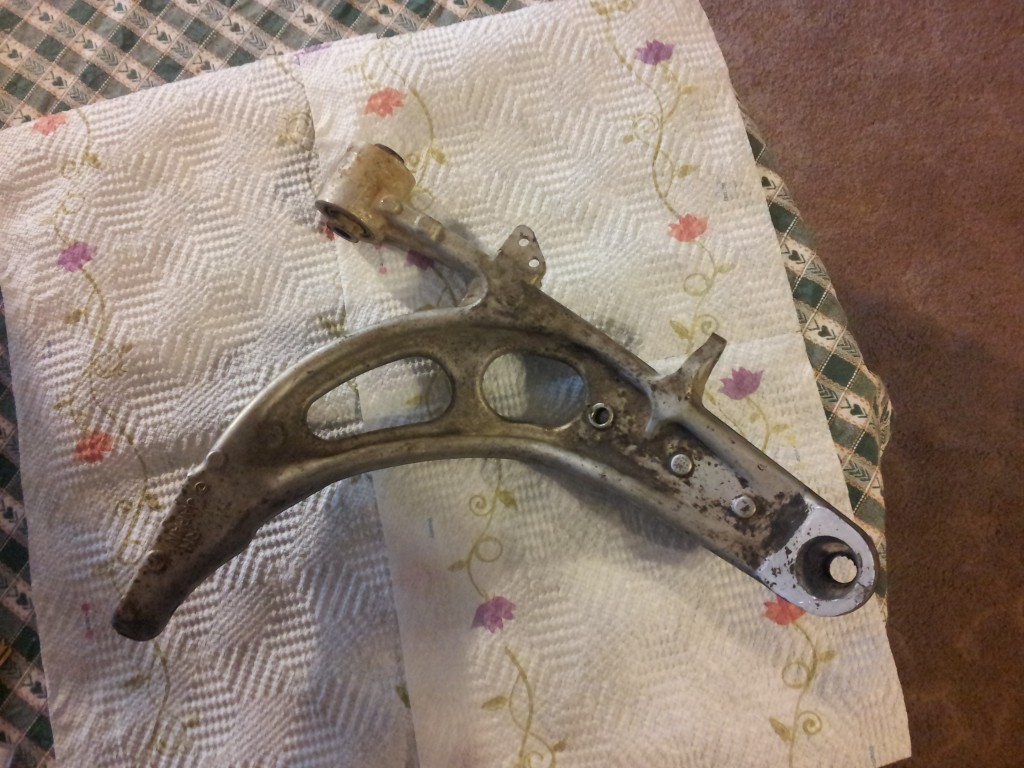 Removed aluminum control arm seen from above on a paper towel