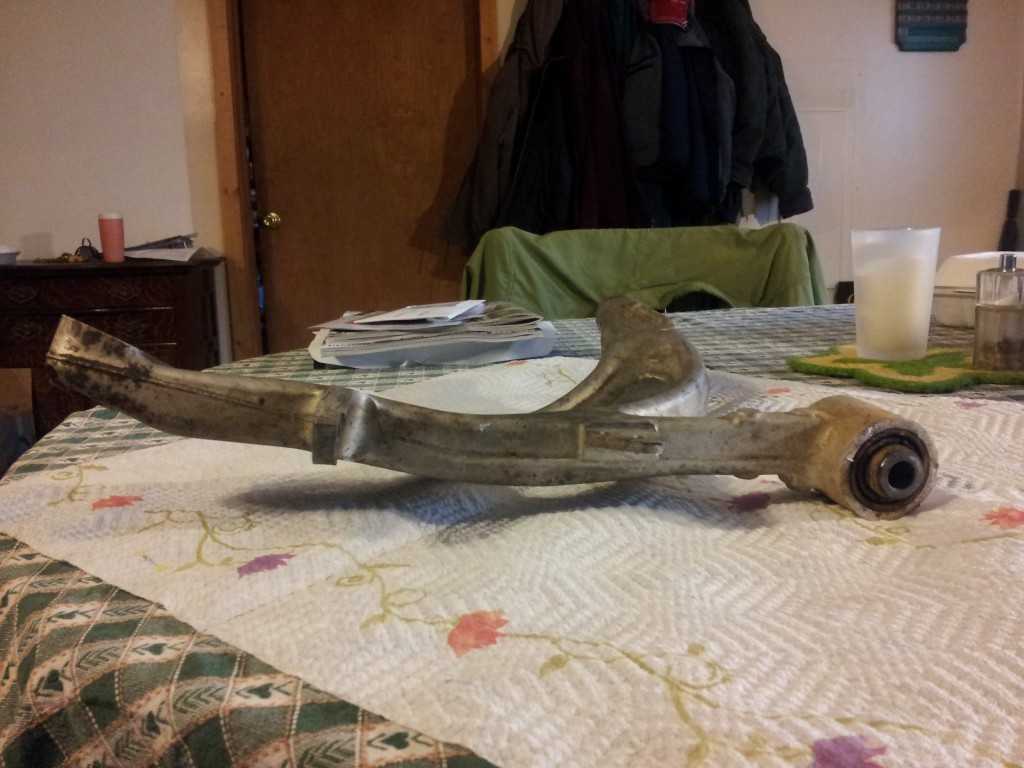 Removed control arm showing its rear bushing