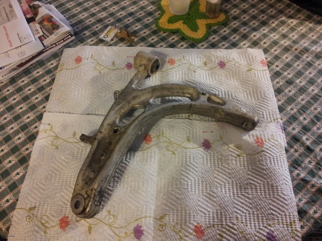 Top view of the removed control arm on the kitchen table