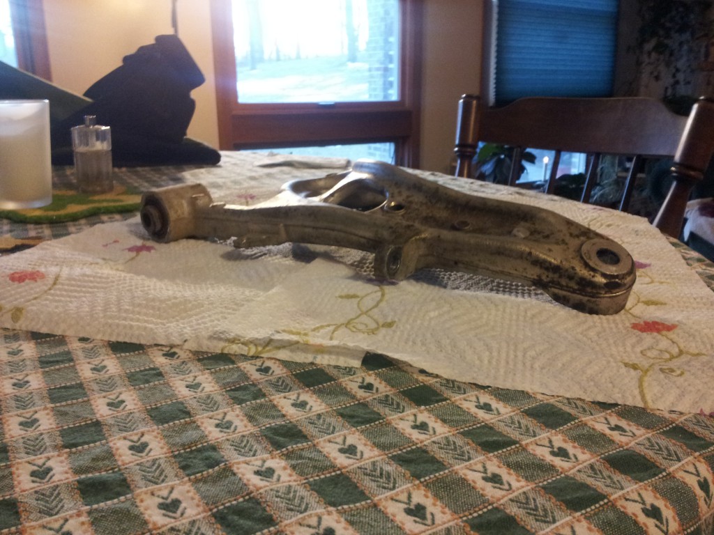 Angled view of the removed control arm on the table