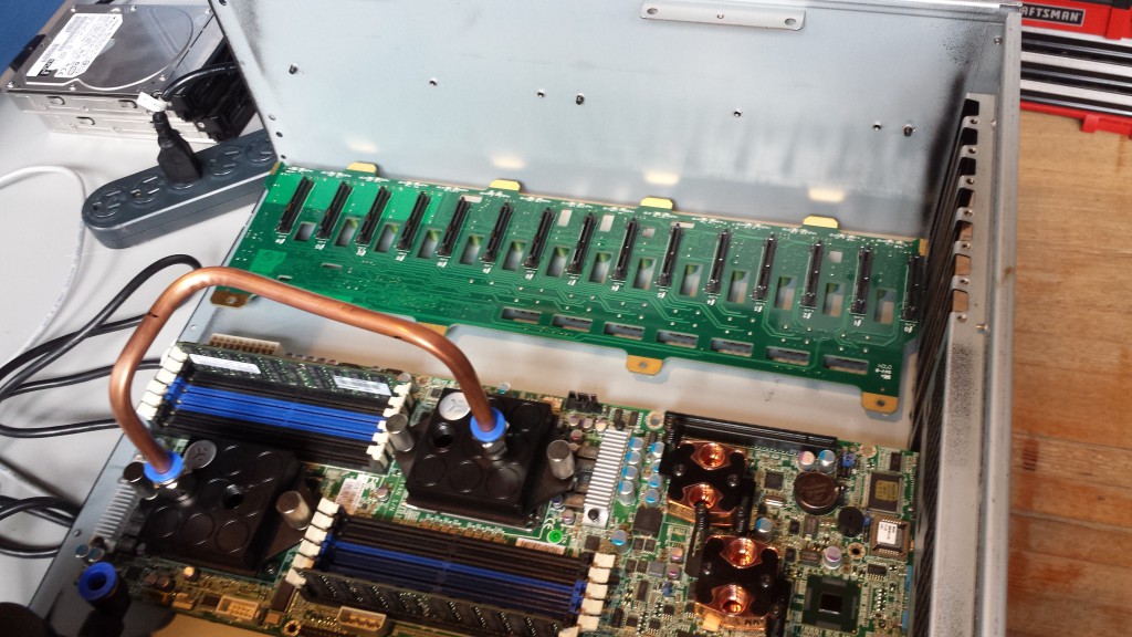 Open server chassis with water-cooled CPU blocks connected by copper tubing